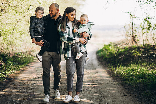 A family walks through a forest